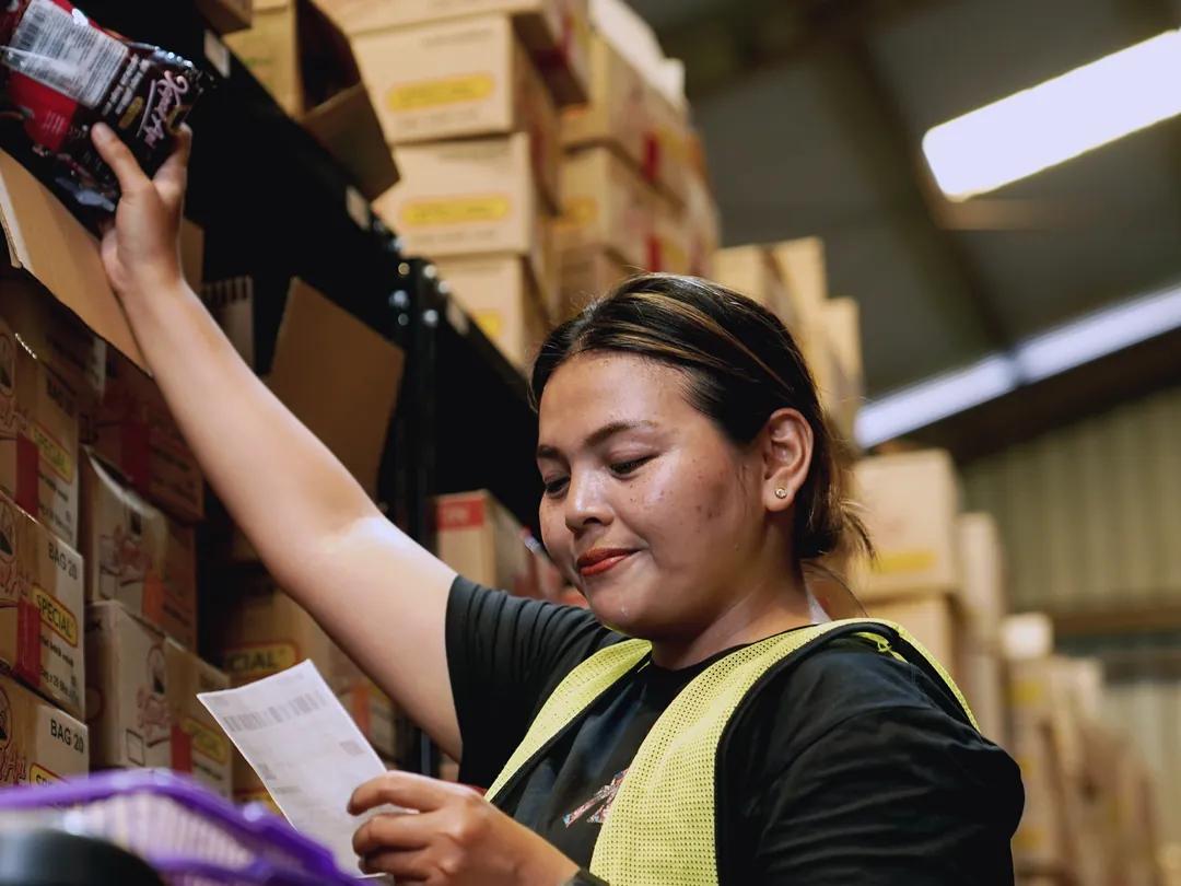 Biteship warehouse staff picking orders from a list